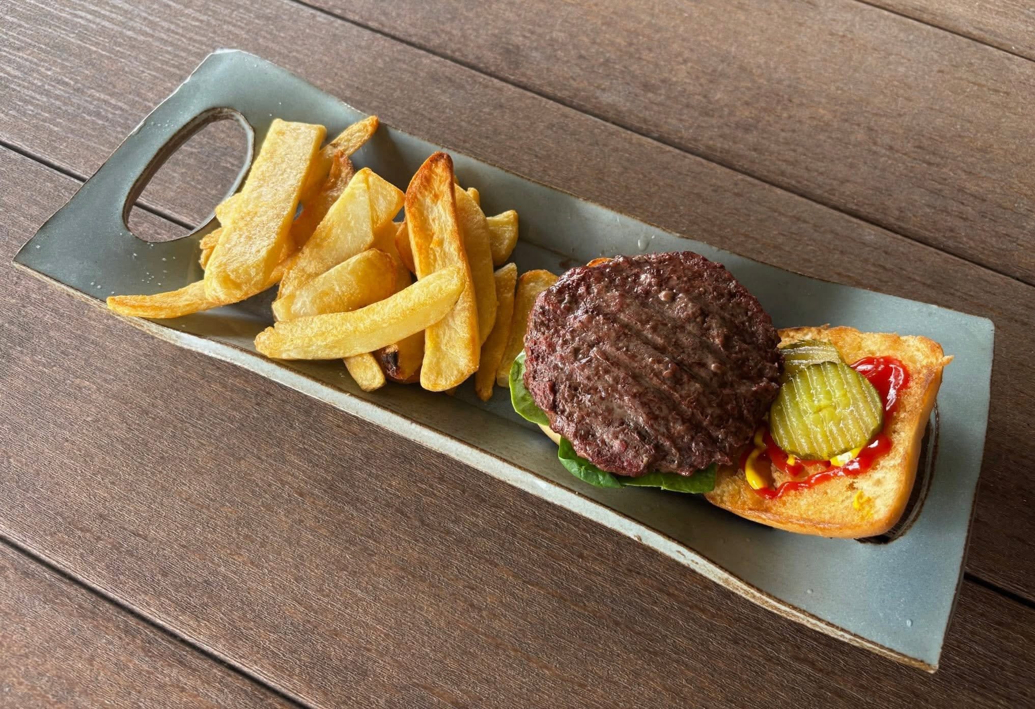Wagyu burger with fries on a slate board